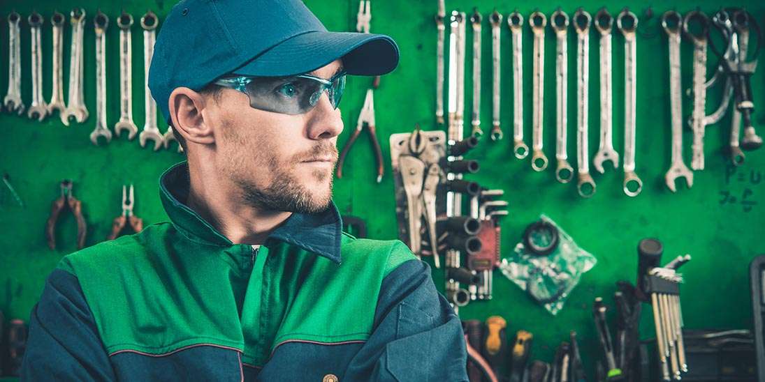 mechanic with tools in background